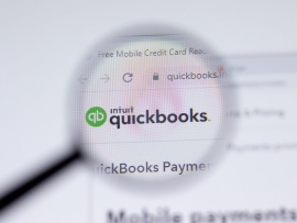 Intuit Quickbooks Online in a browser under a magnifying glass.