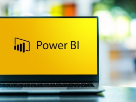 Power BI logo on a laptop.